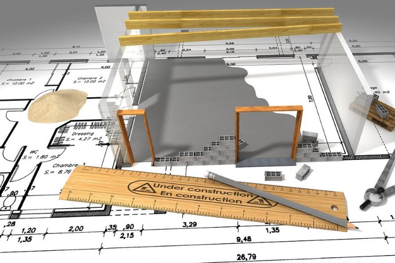 Structural engineering drawings, calculations and blueprints on a desk